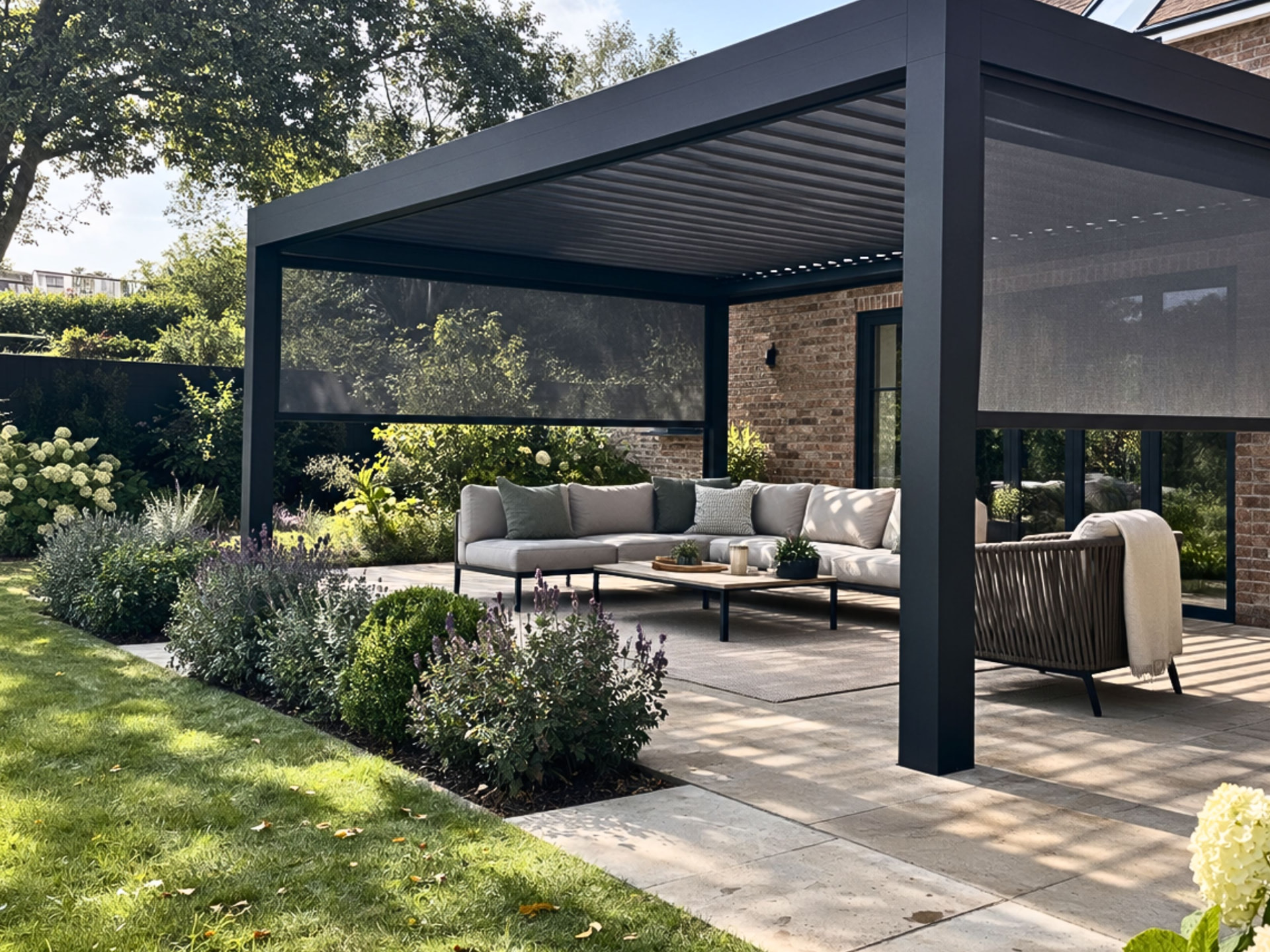 Louv Pro freestanding pergola with garden seating and drop-down screens